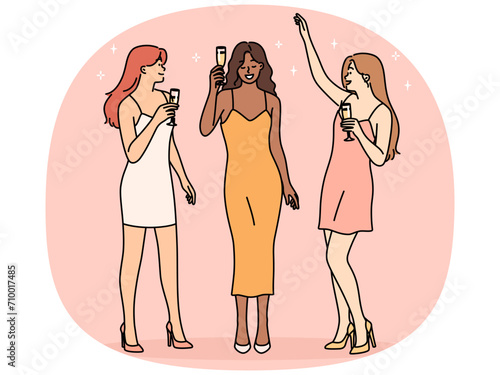 Smiling women drinking champagne on party