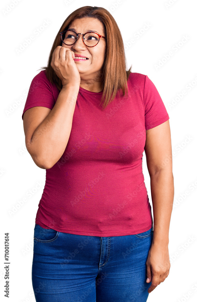 Middle age latin woman wearing casual clothes and glasses looking stressed and nervous with hands on mouth biting nails. anxiety problem. Middle age latin woman wearing casual clothes and glasses looking stressed and nervous with hands on mouth biting nails. anxiety problem.