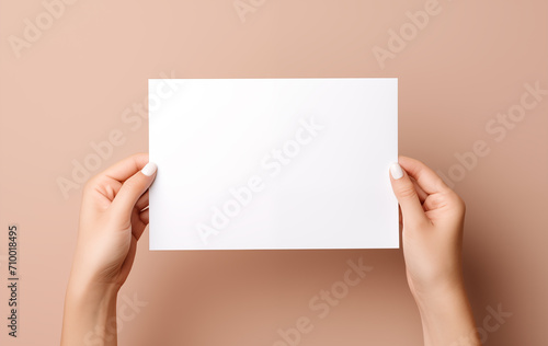 Female hands holding white card on neutral background, card mockup with copy space, Generative AI