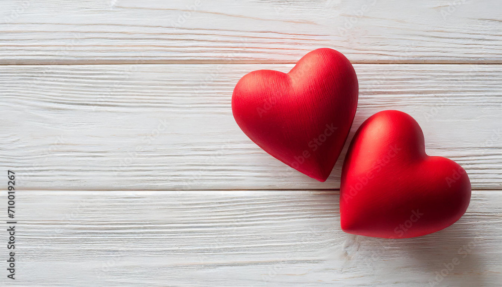 Valentines day background with two red hearts on white wooden table Valentines day background with two red hearts on white wooden table