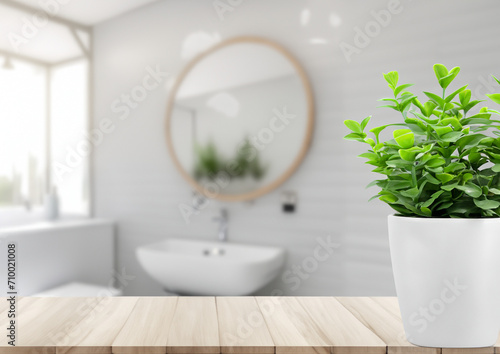 White bathroom interior. Empty wooden table top with plant for product display with blurred bathroom interior background