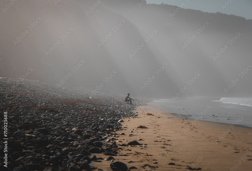 Surfer Sitting on Beach California