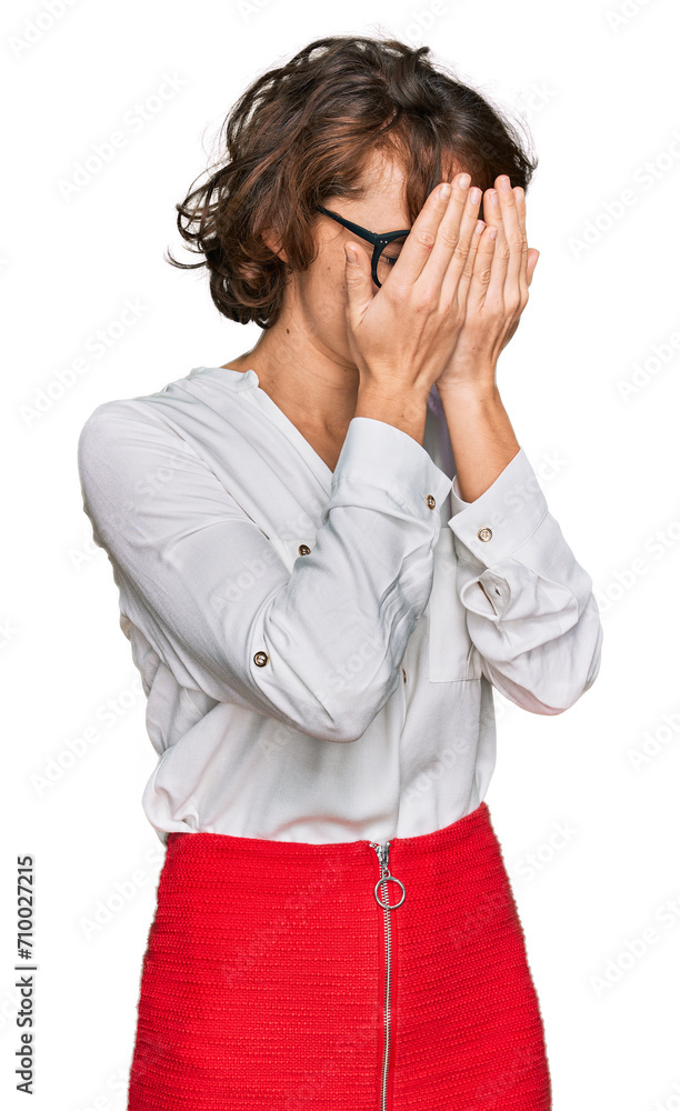 Young hispanic woman wearing business style and glasses with sad expression covering face with hands while crying. depression concept. Young hispanic woman wearing business style and glasses with sad expression covering face with hands while crying. depression concept.