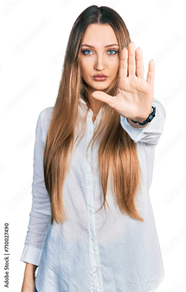 Beautiful caucasian woman wearing casual white shirt doing stop sing with palm of the hand. warning expression with negative and serious gesture on the face. Beautiful caucasian woman wearing casual white shirt doing stop sing with palm of the hand. warning expression with negative and serious gesture on the face.