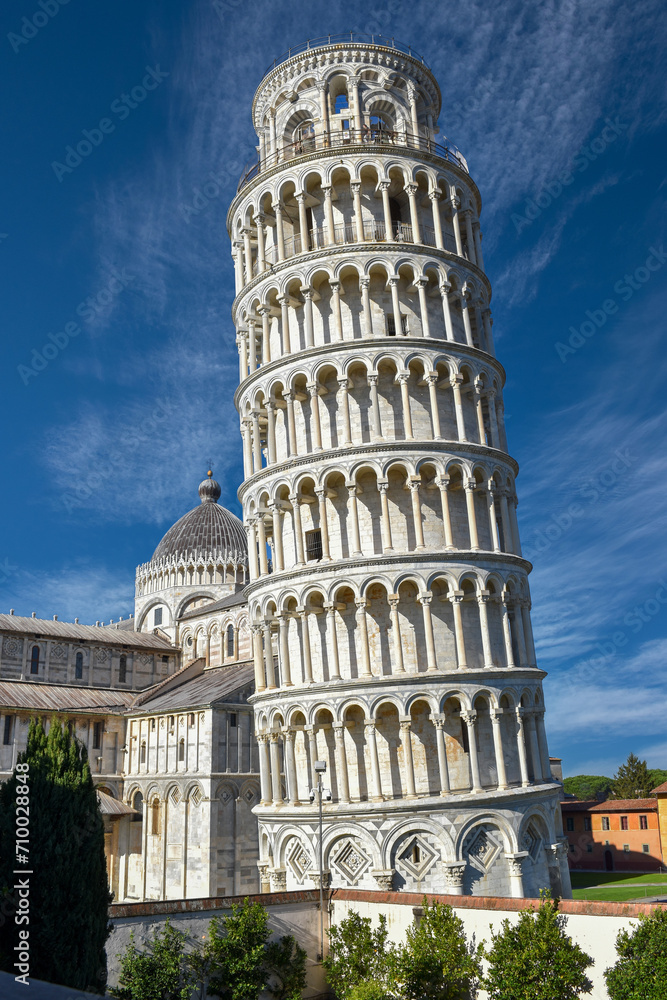 Pisa, Italy - the Leaning Tower of Pisa (14th century)(Torre Pendente) behind the Cathedral  on  blue sky
