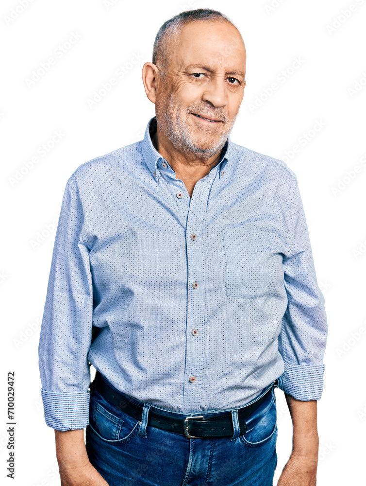 Senior man with grey hair and beard wearing casual blue shirt relaxed with serious expression on face. simple and natural looking at the camera. Senior man with grey hair and beard wearing casual blue shirt relaxed with serious expression on face. simple and natural looking at the camera.