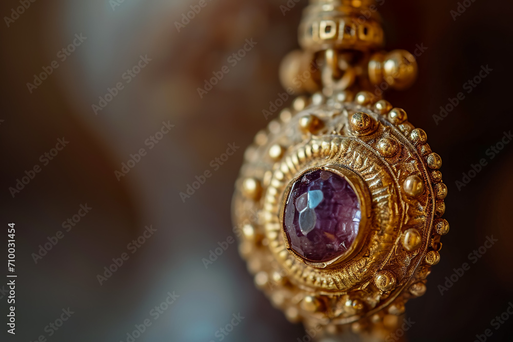 Fototapeta premium close-up of a gold earring, with a gemstone in the center