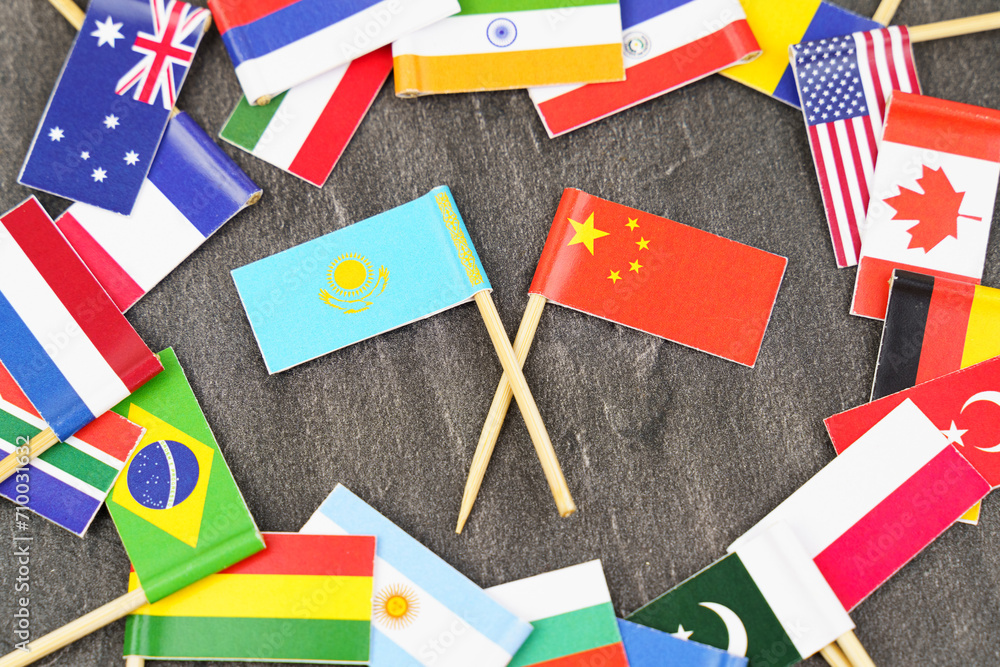 The concept is diplomacy. In the middle among the various flags are two flags - China, Kazakhstan The concept is diplomacy. In the middle among the various flags are two flags - China, Kazakhstan