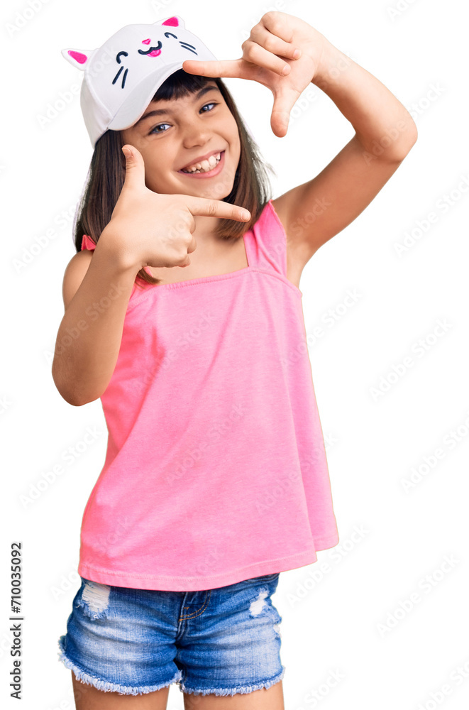 Young little girl with bang wearing funny kitty cap smiling making frame with hands and fingers with happy face. creativity and photography concept. Young little girl with bang wearing funny kitty cap smiling making frame with hands and fingers with happy face. creativity and photography concept.