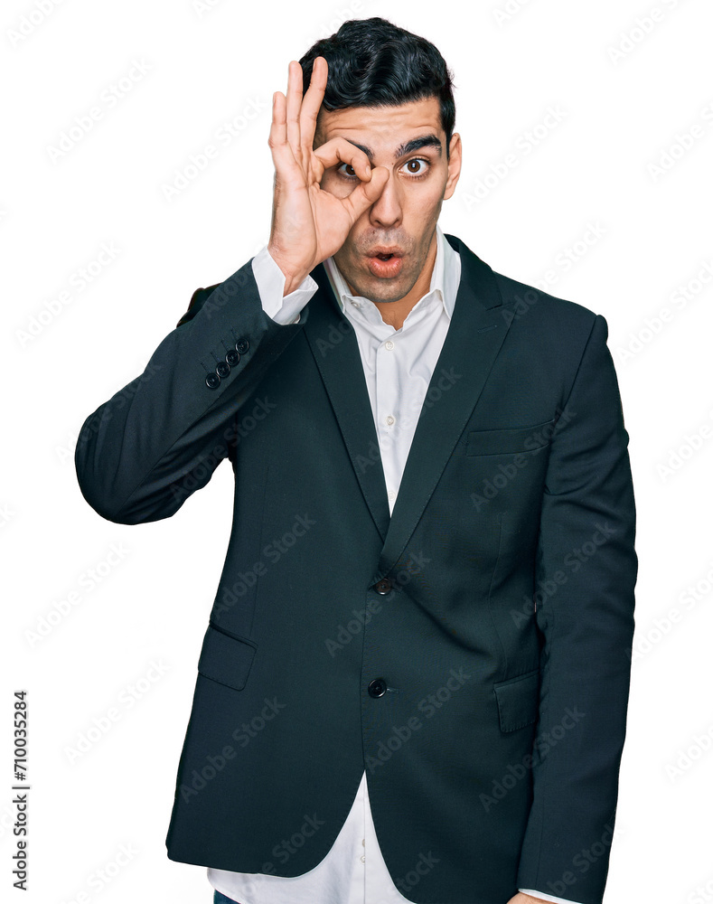 Handsome hispanic man wearing business clothes doing ok gesture shocked with surprised face, eye looking through fingers. unbelieving expression. Handsome hispanic man wearing business clothes doing ok gesture shocked with surprised face, eye looking through fingers. unbelieving expression.