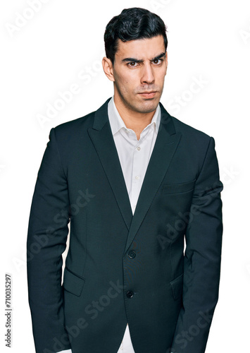 Handsome hispanic man wearing business clothes skeptic and nervous, frowning upset because of problem. negative person.