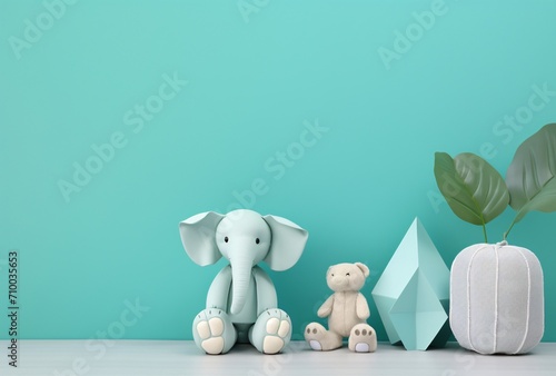 stuffed elephant toy next to other toys and decor on a blue wall, light white and cyan