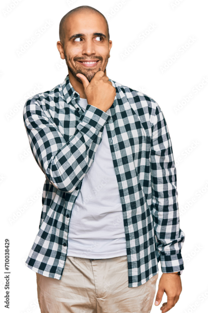 Hispanic adult man wearing casual clothes with hand on chin thinking about question, pensive expression. smiling with thoughtful face. doubt concept. Hispanic adult man wearing casual clothes with hand on chin thinking about question, pensive expression. smiling with thoughtful face. doubt concept.