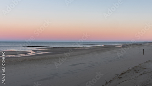 The beach of North Holland  Netherlands  looks deserted on this morning. The rising sun creates beautiful pastel colors.
