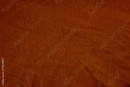 Dark deep burnt orange red brown terracotta texture background for design. Wrinkled crumpled natural cotton fabric cloth. Color.