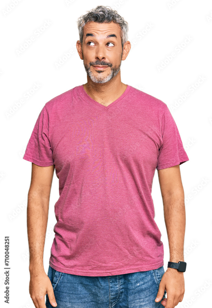 Middle age grey-haired man wearing casual clothes smiling looking to the side and staring away thinking. Middle age grey-haired man wearing casual clothes smiling looking to the side and staring away thinking.