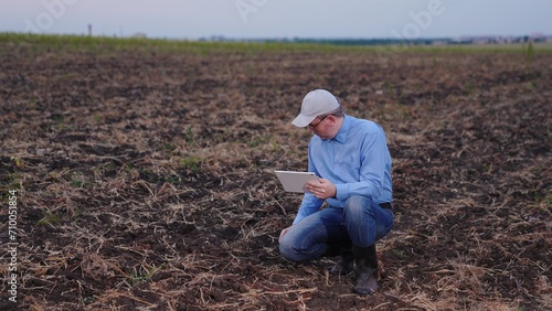 farmer looks soil field, farms, agronomist works unpaved soil, plowed soil field, farmer works hand digital tablet, electronics, walking, row, control, sales, teamwork, plant, glad, partners