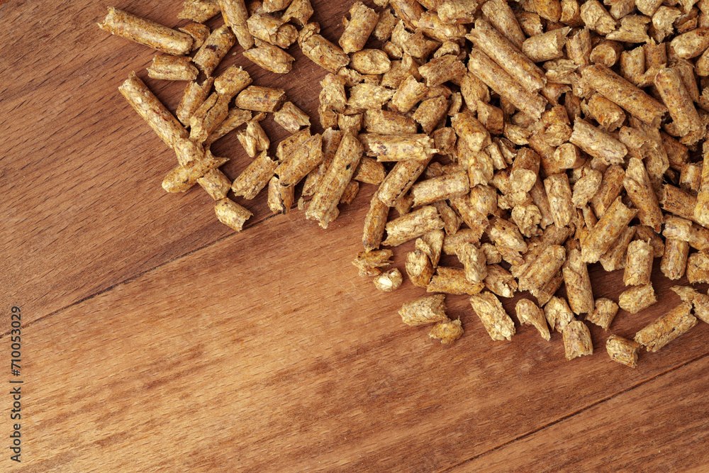 Heap of wooden pellets biofuel on wooden table Heap of wooden pellets biofuel on wooden table