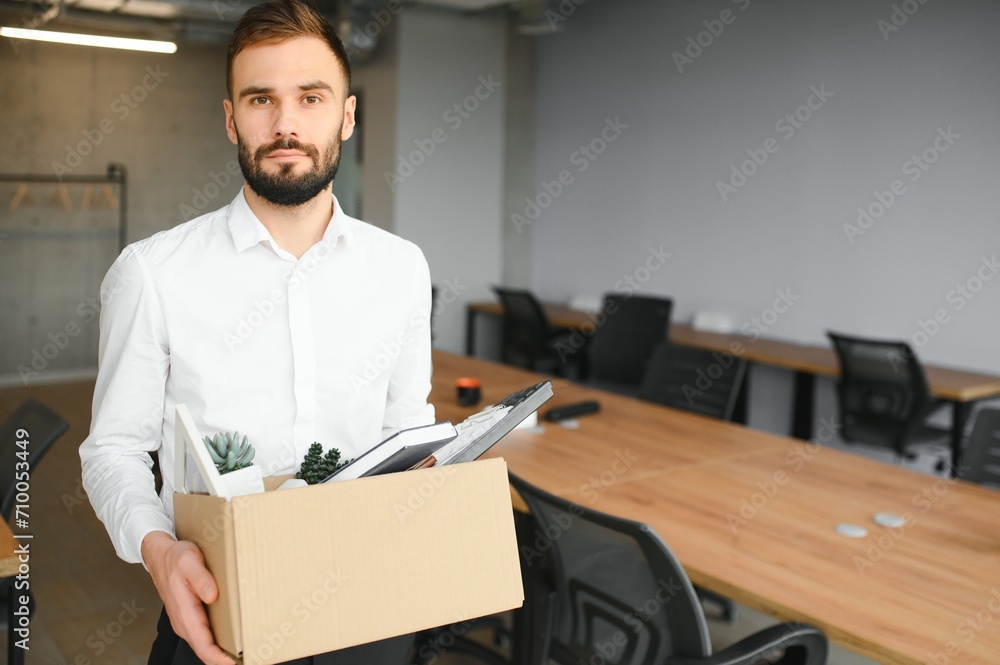 Man by dismissal. Guy lost job. Fired manager in company. Dismissal box in hands of employee. Man by dismissal. Guy lost job. Fired manager in company. Dismissal box in hands of employee.