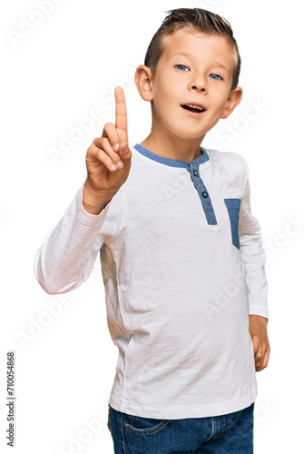 Adorable caucasian kid wearing casual clothes showing and pointing up with finger number one while smiling confident and happy.