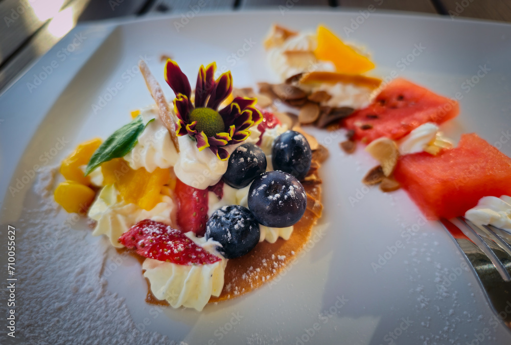 Dessert with whipped cream and fruits such as blueberry, strawberry and watermelon etc.