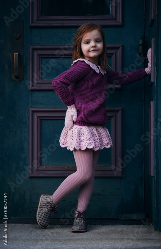 cute little girl in handmade knitted outfit. cozy knitted garments. craft, hobby, DIY fashion © Olesia Bilkei