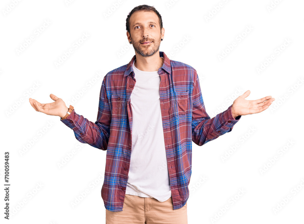 Young handsome man wearing casual clothes smiling showing both hands open palms, presenting and advertising comparison and balance Young handsome man wearing casual clothes smiling showing both hands open palms, presenting and advertising comparison and balance