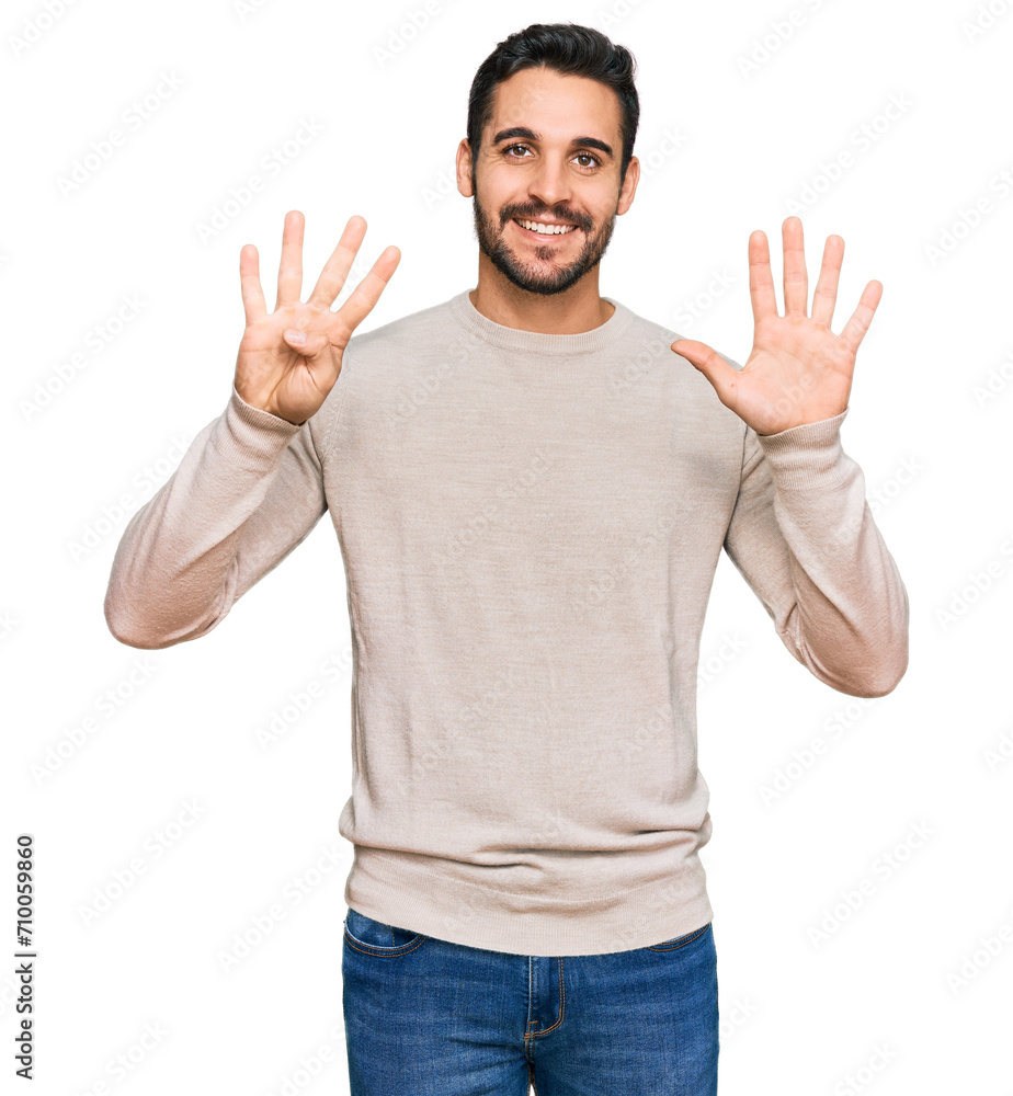 Fototapeta premium Young hispanic man wearing casual clothes showing and pointing up with fingers number nine while smiling confident and happy.