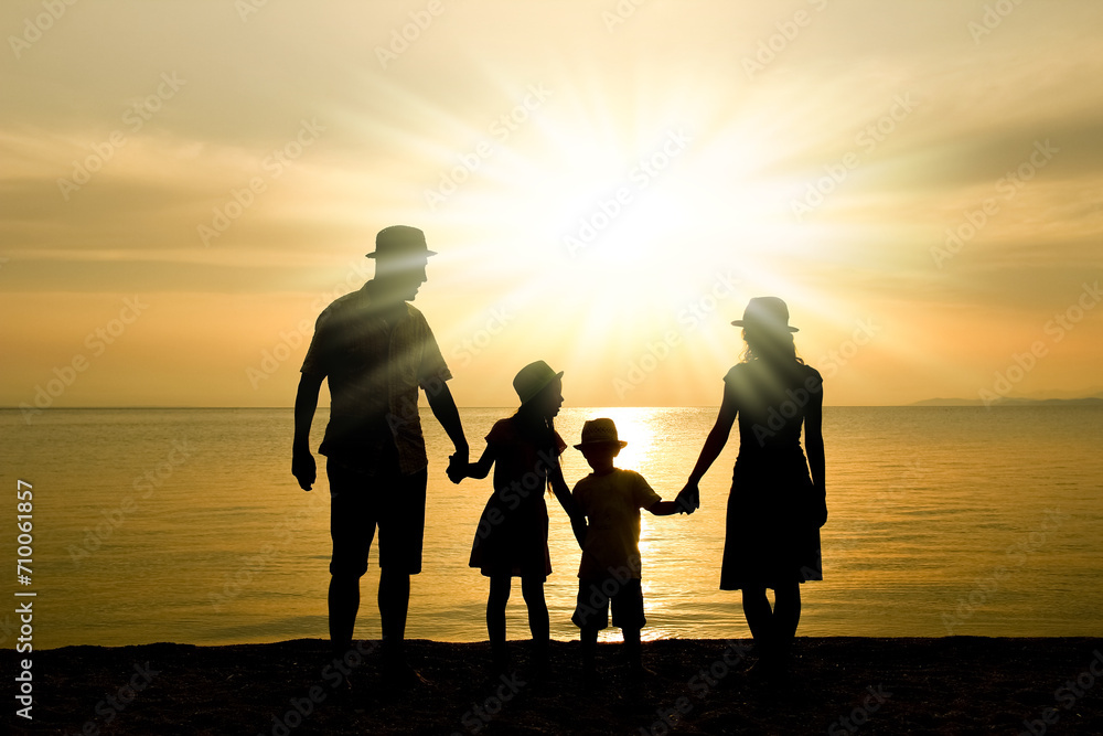 A happy family in nature by the sea on a trip silhouette