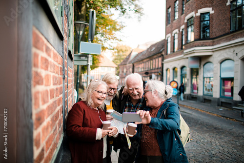 Senior people taking group photo on city vacation