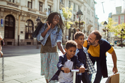 Happy diverse family walking together in urban setting