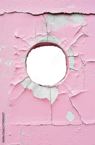 torn hole in a old cracked fuscia pink concrete wall. Peeling old fuscia pink paint. Cracked and peeling, Grunge wall texture. Worn aged post apocalyptic texture background with a hole in the wall.