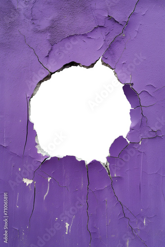 torn hole in a old cracked grape purple concrete wall. Peeling old grape lilac paint. Cracked and peeling, Grunge wall texture. Worn aged post apocalyptic texture background with a hole in the wall.