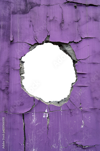 torn hole in a old cracked lilac concrete wall. Peeling old lilac paint. Cracked and peeling, Grunge wall texture. Worn aged post apocalyptic texture background with a hole in the wall.