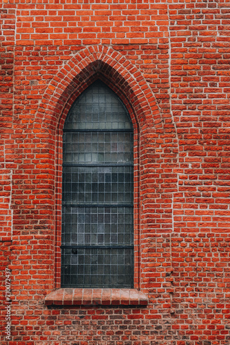 side window of a historic red brick church - Gothic style 
