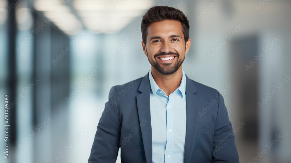 Cheerful businessman in a formal suit with a genuine smile, positioned in an airy office space that suggests innovation and forward-thinking, themes of entrepreneurship and progressive business Cheerful businessman in a formal suit with a genuine smile, positioned in an airy office space that suggests innovation and forward-thinking, themes of entrepreneurship and progressive business