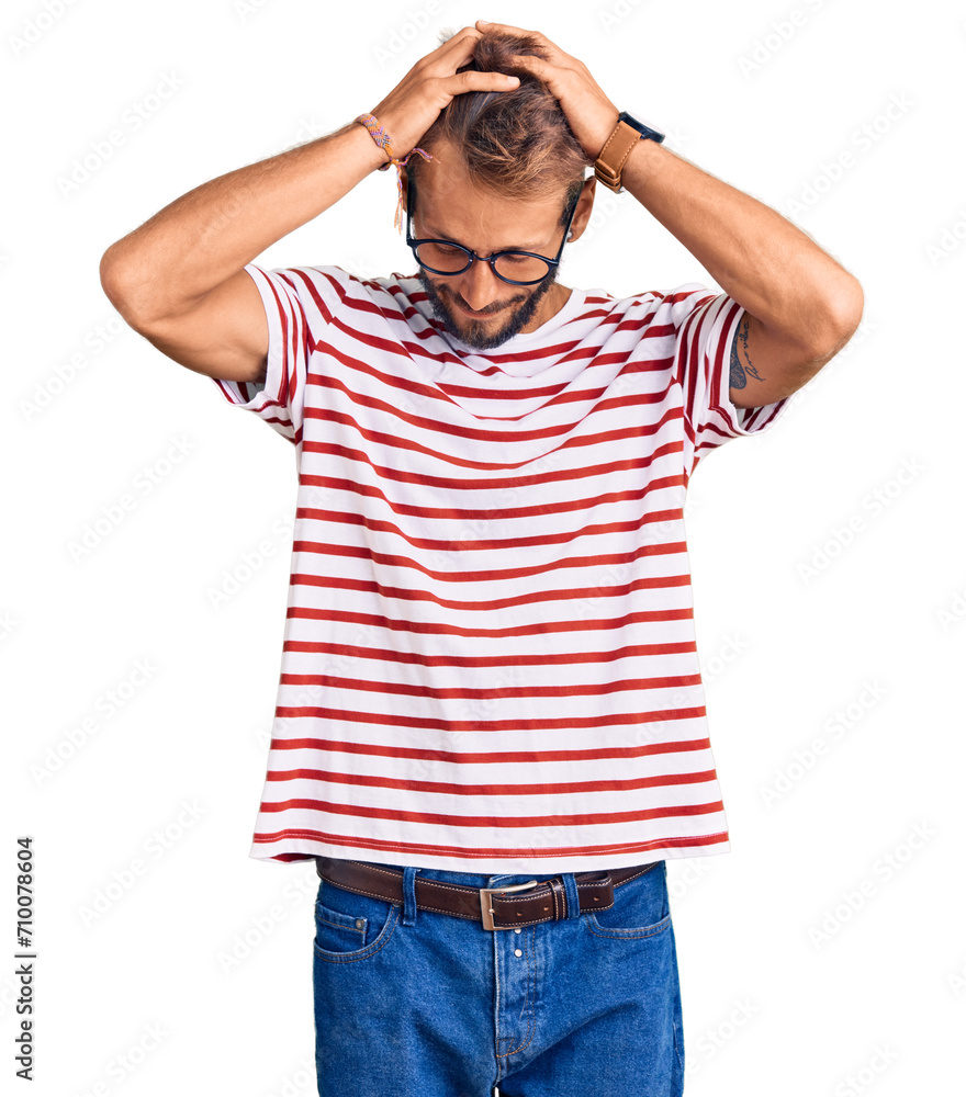 Handsome blond man with beard wearing casual clothes and glasses suffering from headache desperate and stressed because pain and migraine. hands on head. Handsome blond man with beard wearing casual clothes and glasses suffering from headache desperate and stressed because pain and migraine. hands on head.