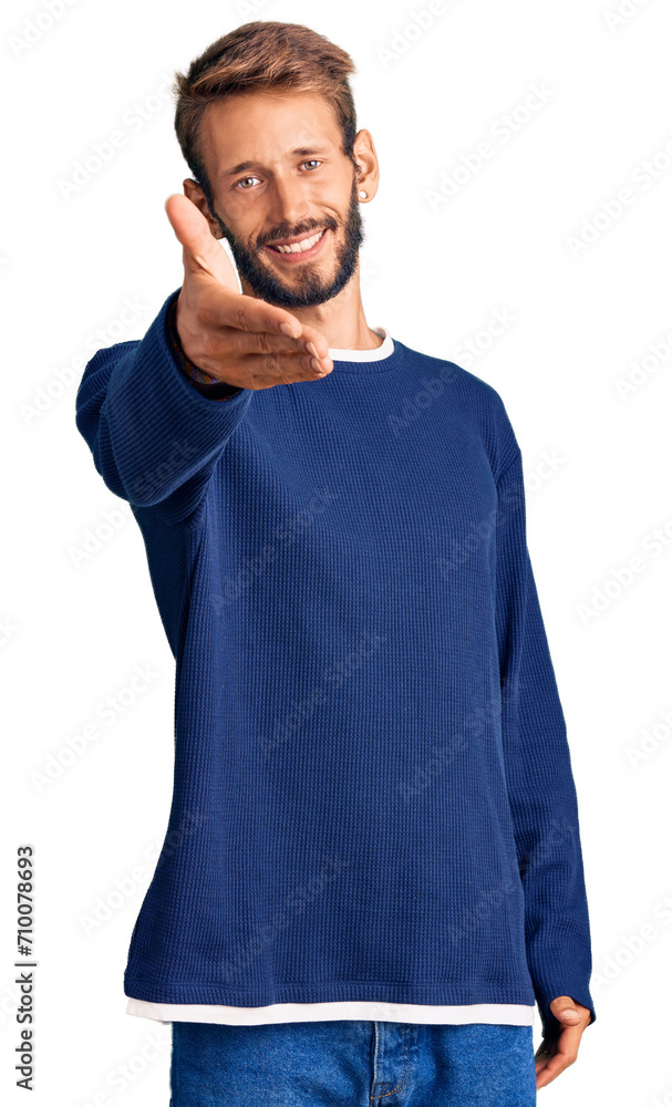 Handsome blond man with beard wearing casual sweater smiling cheerful offering palm hand giving assistance and acceptance. Handsome blond man with beard wearing casual sweater smiling cheerful offering palm hand giving assistance and acceptance.