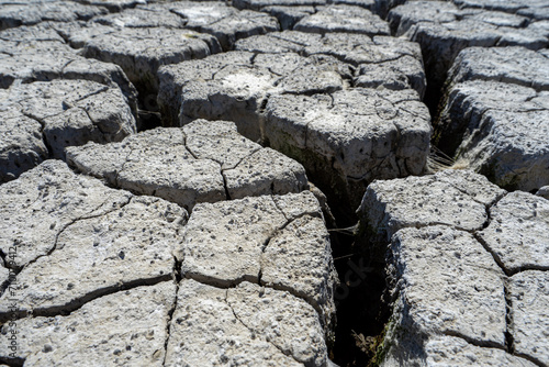 dry and cracked floor of dry river of caldera grande in the city of Barreiro with a small stream. photo