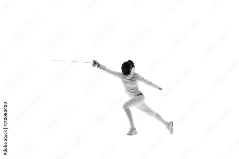 Strength and grace. Illustrating the combination of strength and grace necessary in the art of fencing. Female athlete, fencer in motion over white background. Concept of sport, competition, hobby Strength and grace. Illustrating the combination of strength and grace necessary in the art of fencing. Female athlete, fencer in motion over white background. Concept of sport, competition, hobby