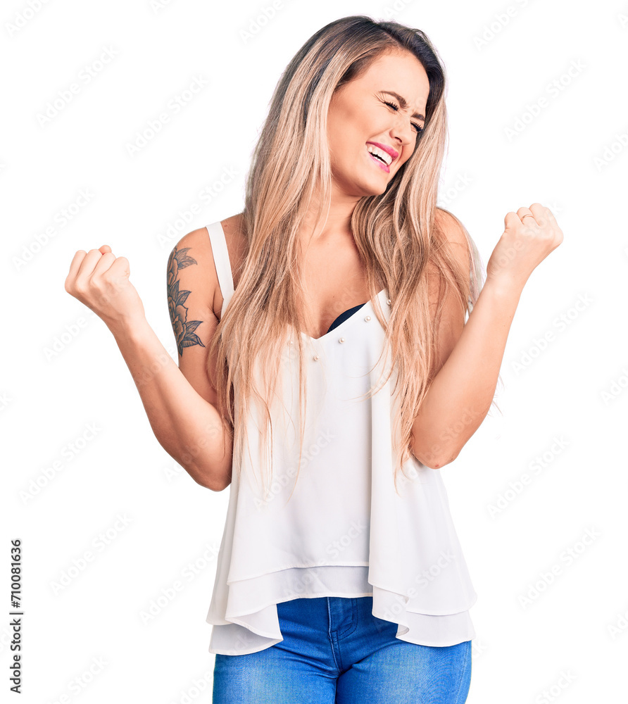 Fototapeta premium Young beautiful blonde woman wearing sleeveless t-shirt very happy and excited doing winner gesture with arms raised, smiling and screaming for success. celebration concept.