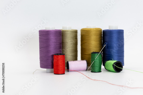 A group of spools and thread in different colors