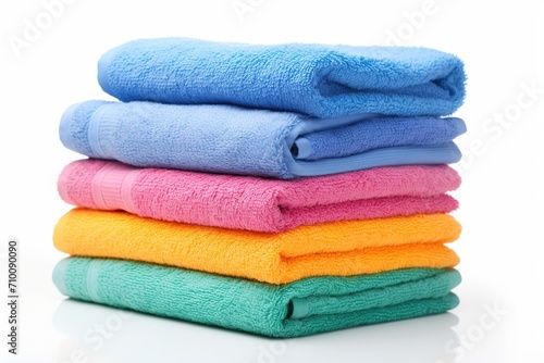Colorful folded bath towels on white background