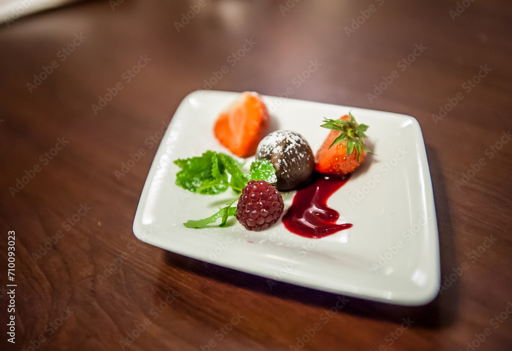 Tasty dessert with berries on a white plate.. Tasty dessert with berries on a white plate..