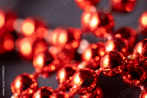 Red and bright Christmas pearls, Christmas tree decorations, garlands, decorations. Close-up macro photography