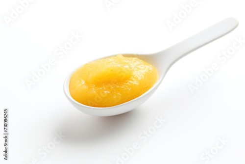 Spoon with baby food on white background