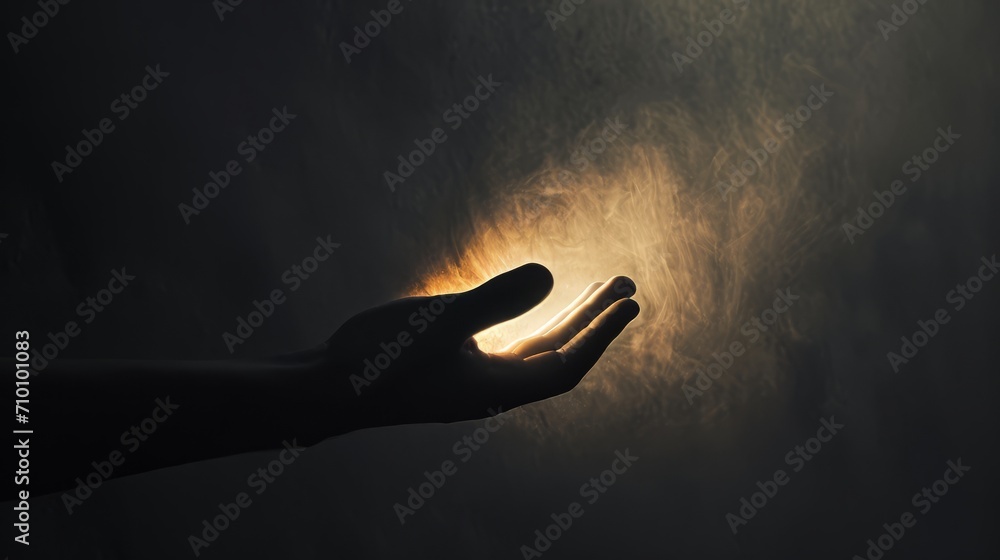 A conceptual photograph of a hand reaching out from the darkness towards a glowing light, symbolizing hope and uncertainty. The minimalistic composition and contrast of warm and cool tones.   - obrazy, fototapety, plakaty 