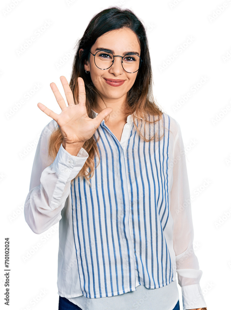Beautiful hispanic woman wearing casual striped shirt showing and pointing up with fingers number five while smiling confident and happy.