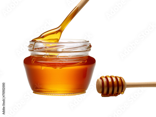 a jar of honey with a wooden spoon