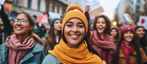 Group of female protesters advocate for gender empowerment and equality by displaying signs and rallying on a street.